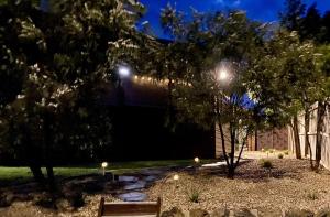 a park at night with trees and a building at The Cosy Bungalow in Portarlington