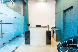 a room with blue walls and a glass counter at Treebo Trend Udyam Glory in Nagpur