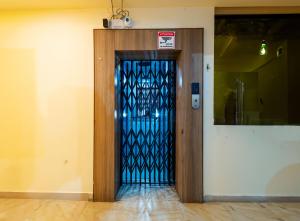 a blue glass door with a sign on it at Treebo Trend Udyam Glory in Nagpur