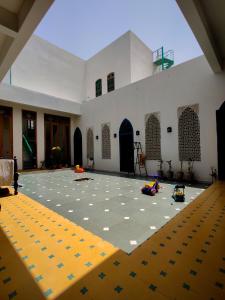 a large room with a large floor with toy cars in it at Aangan Boutique Homestay With Art Center in Courtyard House in Udaipur +35 photos