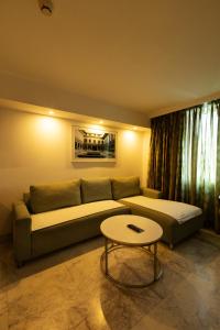 a living room with a couch and a table at Fairfield by Marriott Pune Kharadi in Pune