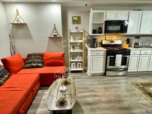 a living room with a red couch and a kitchen at DreamStay in Dacula