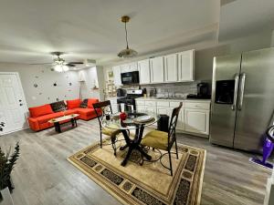 a kitchen and living room with a table and a refrigerator at DreamStay in Dacula