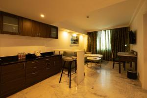 a kitchen with a counter and a table and chairs at Fairfield by Marriott Pune Kharadi in Pune
