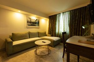 a living room with a couch and a table at Fairfield by Marriott Pune Kharadi in Pune