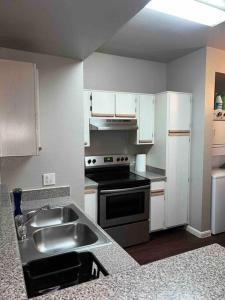 a kitchen with a sink and a stove at Everything you need to call home in Norman