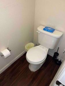 a bathroom with a white toilet with a blue towel on it at Everything you need to call home in Norman