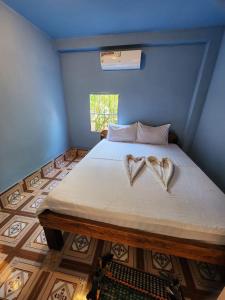 a bedroom with a bed with two hearts on it at Sweet View Guesthouse in Kaôh Rŭng (3)