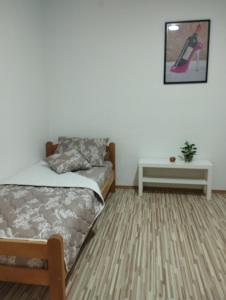a bedroom with a bed and a side table at Apartman Milicevic in Bileća