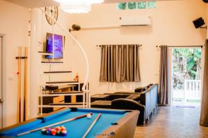 a living room with a pool table at Poomvarin Resort in Ban Wang Takhrai