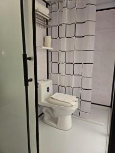 a bathroom with a white toilet in a room at le melur guest house in George Town