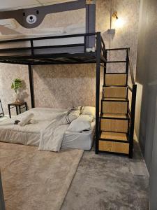 a bedroom with a bunk bed and a spiral staircase at le melur guest house in George Town