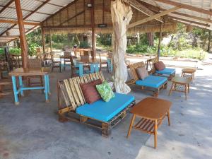 a group of chairs and tables under a pavilion at KAMAKU Bungalows in Koh Rong Sanloem