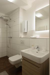 a bathroom with a sink and a toilet and a mirror at Central apartment with Terrace in Duisburg