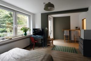 a bedroom with a bed and a desk and a window at Central apartment with Terrace in Duisburg