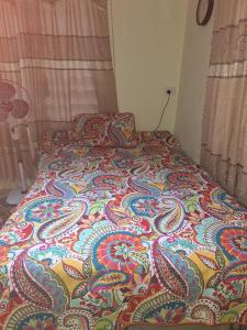 a bed with a colorful blanket on it in a bedroom at awesome stay in Nadi