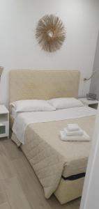 a bedroom with a large bed with a mirror on the wall at Little Rose guest house in Fiumicino