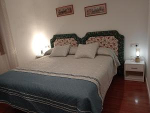 a bedroom with a large bed and two night stands at Zabala, entrañable y auténtica casa de pueblo en Anguiano in Anguiano