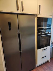 a kitchen with a stainless steel refrigerator and a microwave at Pimp My TLA - TDY in Mackenbach