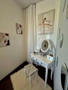 a room with a white desk and a mirror at Central Station Apartment in Cluj-Napoca
