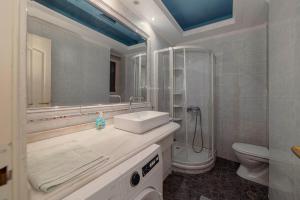a bathroom with a sink and a shower and a toilet at Spacious 2bd apartment next to Athens Archeological museum in Athens