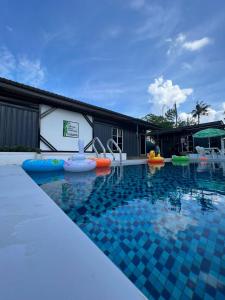 a pool at the resort with inflatables at Rimbun Bayu Homestay in Kuala Terengganu