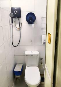 a small bathroom with a toilet and a shower at Bestow Capsule Hostel in Kuala Lumpur