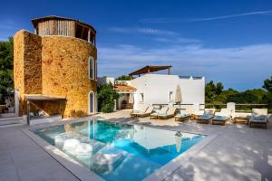 a villa with a swimming pool and a building at Can Taika in Port des Torrent