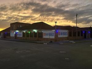 a building with blue lights on the side of a street at ALEXIA LODGE & SPA in Cape Town