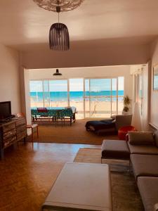 a living room with a view of the beach at Bel appart vue mer in Valras-Plage