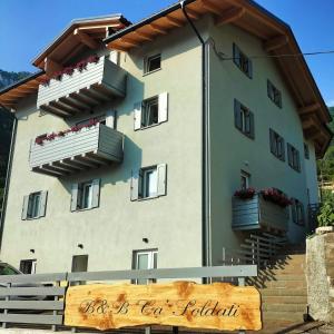 a building with balconies and a sign in front of it at Cà Soldati in Campi