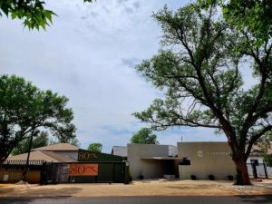 a building with a tree in front of it at 80 on Thabo in Potchefstroom