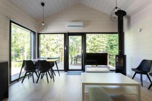 a living room with a table and chairs at Himoskuutio 7 in Jämsä