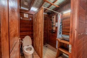 a small bathroom with a toilet and a sink at kamaani cabin in Kubupenlokan