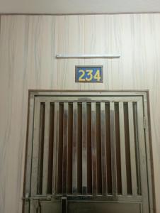 a garage door with a sign on top of it at Home Stay Dwarka19 in New Delhi