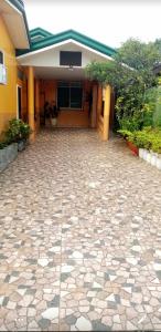 a building with a stone driveway in front of it at Malibu Homes in Casisang