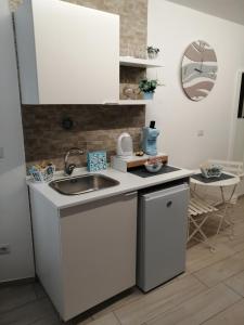 a kitchen with a sink and a counter top at La casa dei nonni in Bari