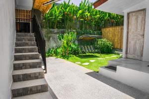 a stairway leading to a yard with a bench at Bali Invest Living in Canggu