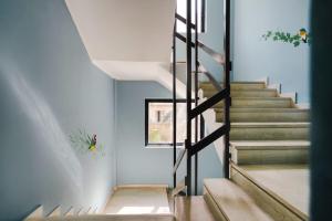 a staircase in a house with a glass wall at Sanders Home Suites in Athens