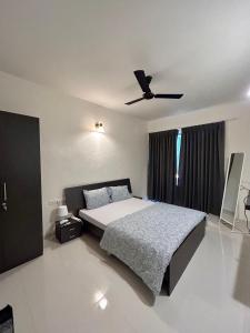 a bedroom with a bed and a ceiling fan at Good Stay Premium 2 BHK Apartment 103 in Vasco Da Gama