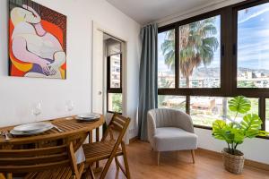 托雷莫利諾斯的住宿－MONKÓ PICASSO，一间带桌椅和窗户的用餐室