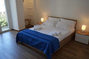 Palazzo Manzoni Apartments في باري: غرفة نوم عليها سرير وفوط