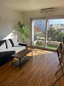 een woonkamer met een bank en een tafel bij Studio Gentilly/Paris 14 in Gentilly +14 foto's