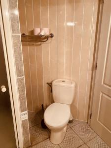 a bathroom with a white toilet in a room at LA MARIEFACTURE - Comme sous les toits in Saint-Avold