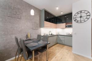 a kitchen and dining room with a table and chairs at Apartament Marengo Ku Morzu by HolidaySun in Sianozety