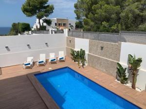 a swimming pool on the roof of a house at 5 bedroom villa in Cala Vadella in Sant Josep de Sa Talaia