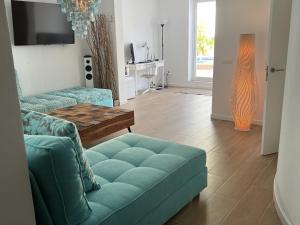 a living room with a couch and a table at 5 bedroom villa in Cala Vadella in Sant Josep de Sa Talaia