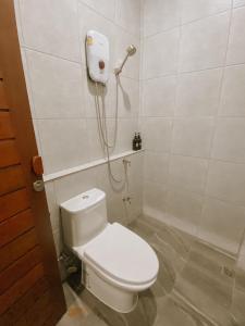 a bathroom with a toilet and a shower at Tachang Airport Hotel in Hat Yai