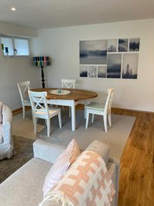 a living room with a table and a couch at Villa Emilia Rottweil in Rottweil +6 photos