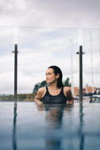 a woman is sitting in the water at Son Spa in Son